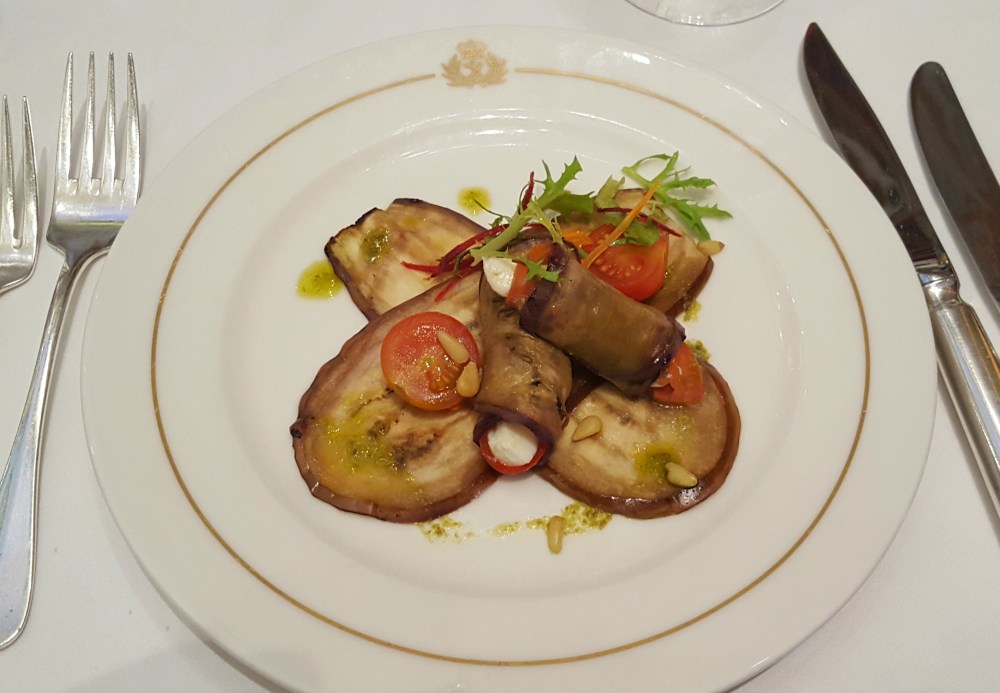 Grilled aubergine, tomato and mozzarella roll with roasted pine nuts and basil pesto